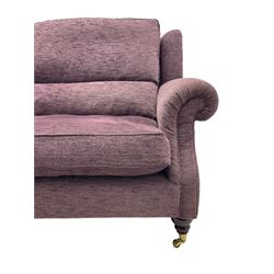 Parker Knoll - pair of large two-seat sofas upholstered in purple fabric, turned mahogany finish front feet with brass cups and castors 
