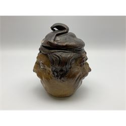 Rare early 20th century Martin Brothers stoneware tobacco jar and cover designed by Robert Wallace Martin, modelled in relief as a smirking face to one side, the other side modelled as the same subject wearing a quizzical expression, the cover formed as a sack hat, incised marks to base 'R W. Martin London & Southall. 10.1.1910', and to inner rim of cover 'R. W. Martin. & Bros London & Southall. 10.1.1910', H18cm

Cf. Waddington's Canada Lot 51 A Private Collection of Martin Brothers Stoneware 06/12/2017
Woolley & Wallace Lot 37 British Art Pottery 01/12/2010