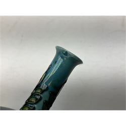 Minton Secessionist vase, with tube-lined stylised flower decoration, upon a blue ground, with printed mark to base 'Minton Ltd, No. 32', H13cm