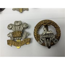 Fourteen cap badges of Irish interest including Royal Dublin Fusiliers inscribed to the slider 'From A. O'Connor 2nd Batt. Dec.2nd 1915', Connaught Rangers, South irish Horse Yeomanry, Inniskilling Fusiliers, Royal Irish Regiment etc; and seven Welsh badges including South Wales Borderers, Welsh Guards, 3rd Bn. Monmouthshire Regt. etc (21)