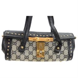 Gucci 'Bamboo Bullet' shoulder handbag, the canvas body with repetitive GG logo design and black studded leather border, with gold tone clasp impressed Gucci, and bamboo handle, with interior zip pocket, serial no. 910998 9019 impressed to interior leather, with Gucci satin dust bag, H14cm, W20cm