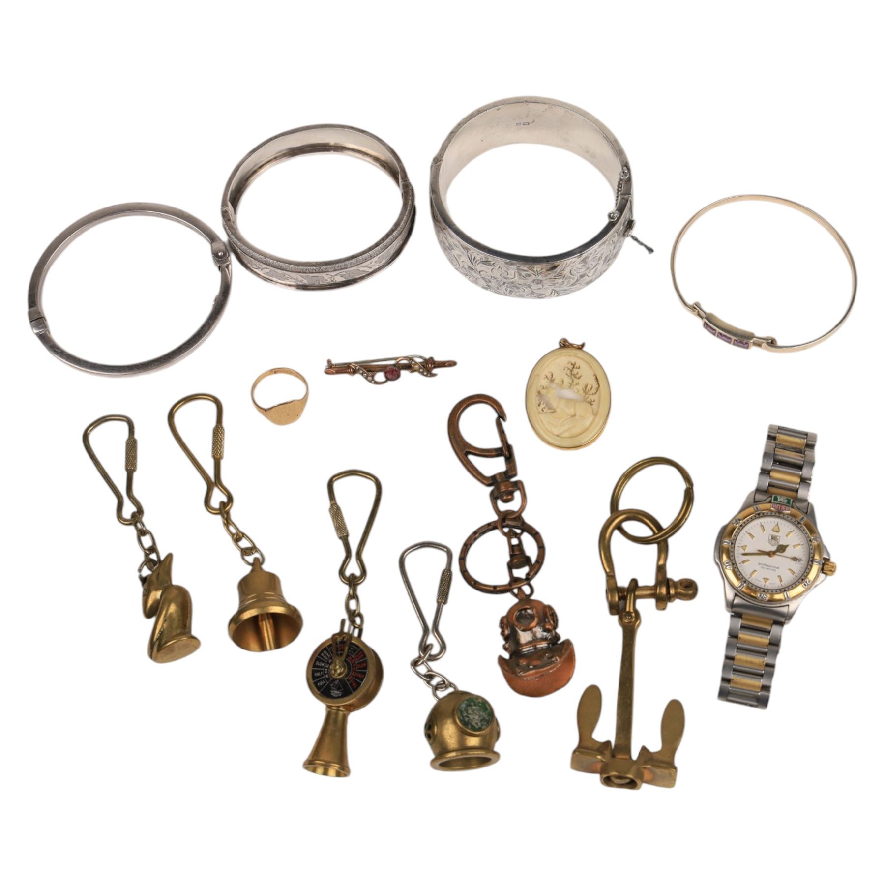 9ct gold jewellery, including bone deer pendant in gold mount, signet ring and stone set brooch, all stamped or hallmarked, three silver bangles, base metal bangle, brass diving related keychains and a Tag Heuer quartz wristwatch