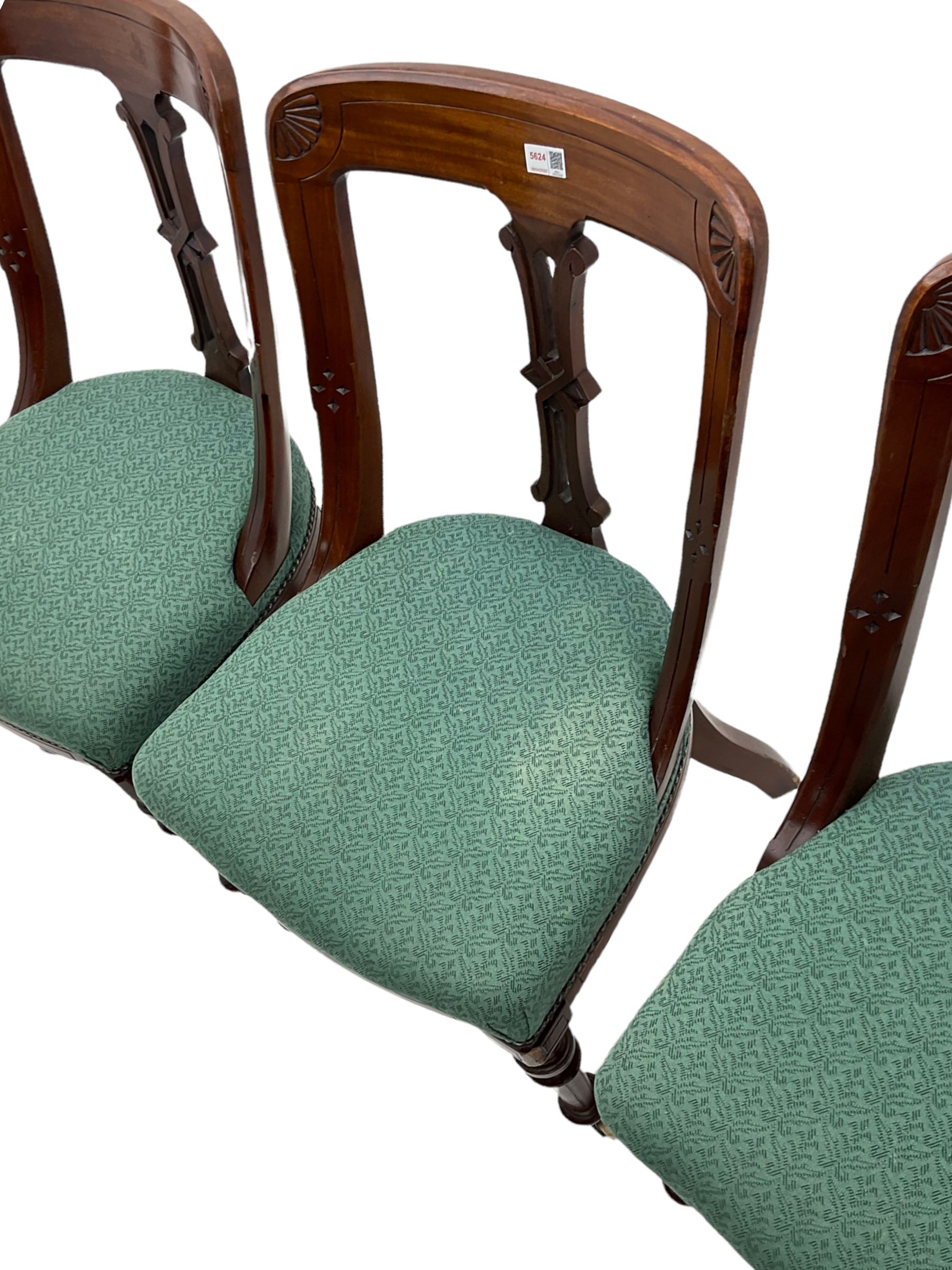 Set of four Victorian mahogany spoon back dining chairs, upholstered seats