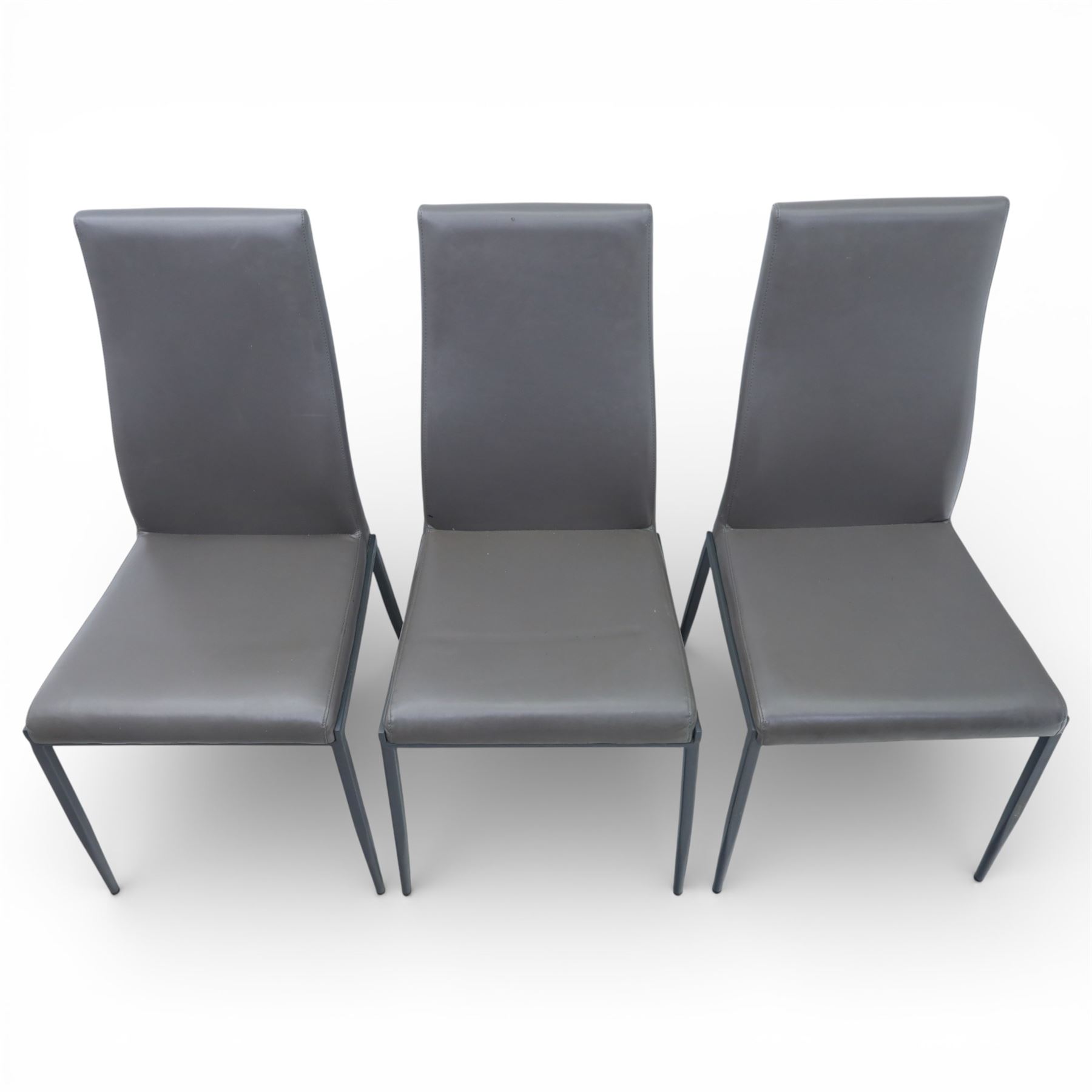 Modern composite marble effect dining table, rectangular top with simulated veining supported on a block pedestal base, accompanied by six matching dining chairs with padded seats and backs in grey upholstery on slim metal legs