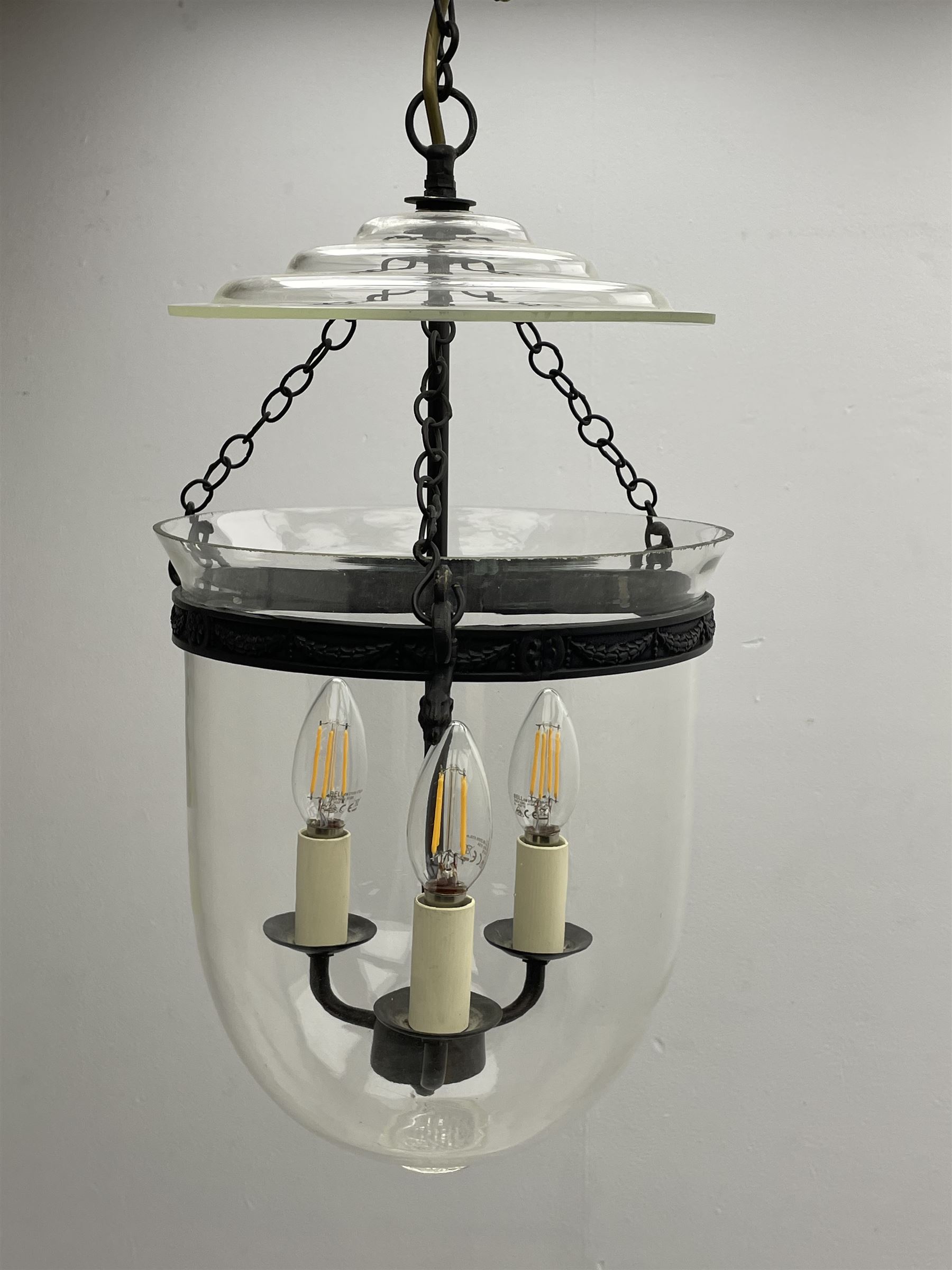 Vaughan Designs - Regency design bronzed metal and glass hall lantern, three branch light in glass bell, the band decorated with bell flower garlands and serpentine mythical beast chain brackets