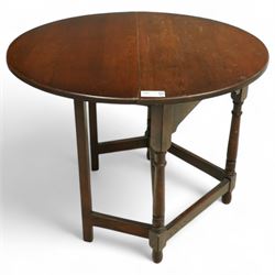 20th century oak drop-leaf table, of gateleg form with oval top, raised on turned legs and...