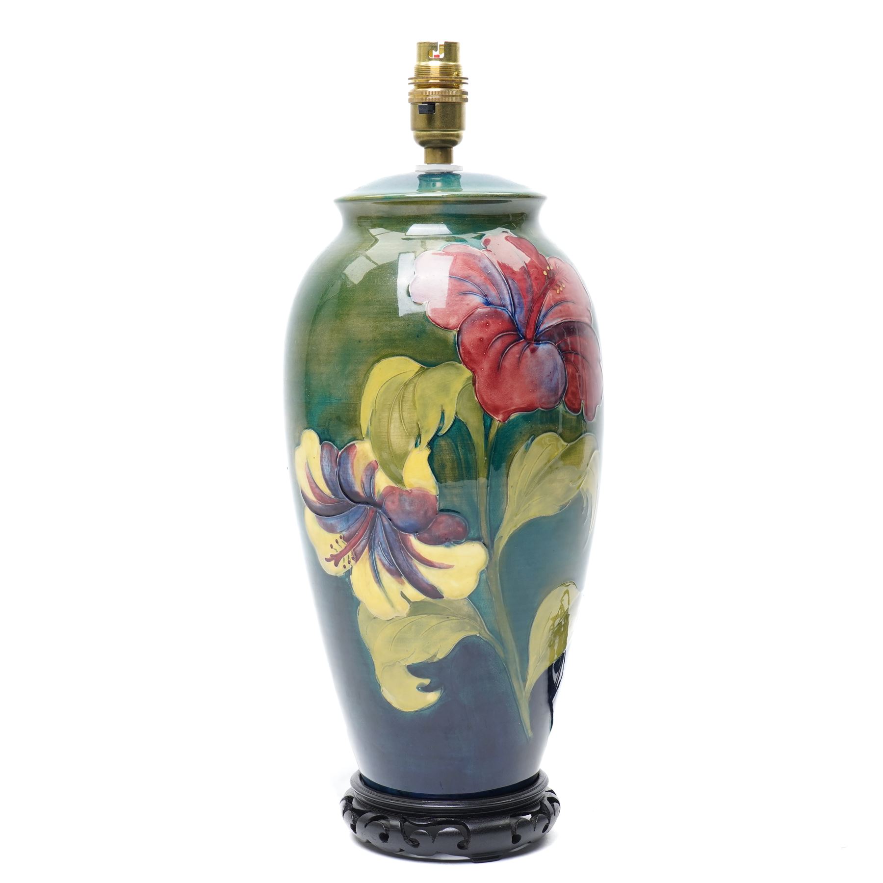 Moorcroft 'Hibiscus' pattern table lamp on green ground, including stand and fittings H42cm