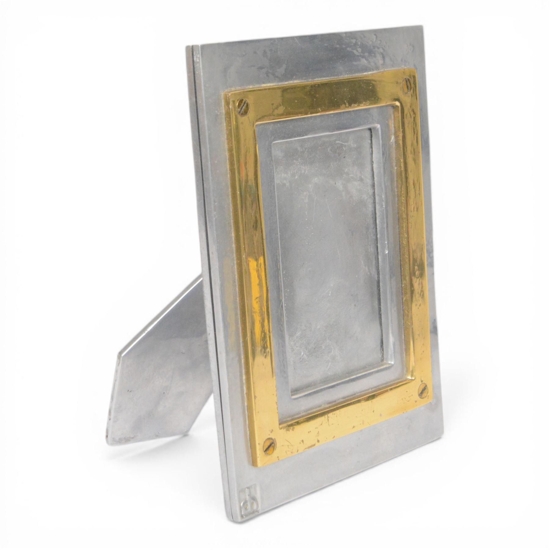 David Marshall photo frame, of cast aluminium mounted with a smaller brass frame, the maker's mark impressed to the lower left hand corner, H23cm