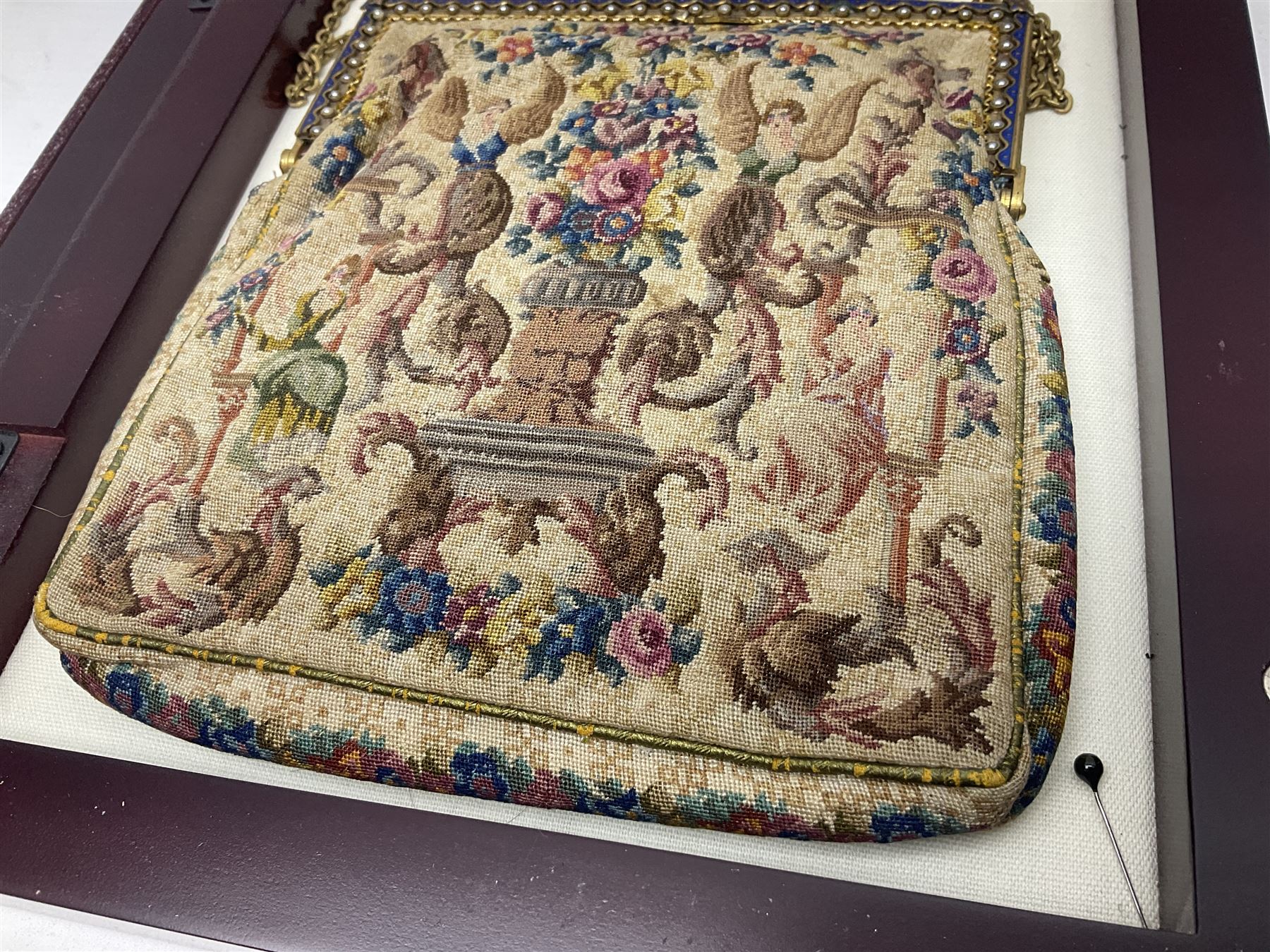 Continental petit point evening bag, with enamel and pearl details, in wooden display frame, together with a snake skin handbag and three other vintage bags