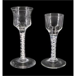 Two 18th century drinking glasses, with ogee bowls, one waisted and part honeycomb moulded, upon double series opaque twist stems and conical feet, tallest H15cm 
