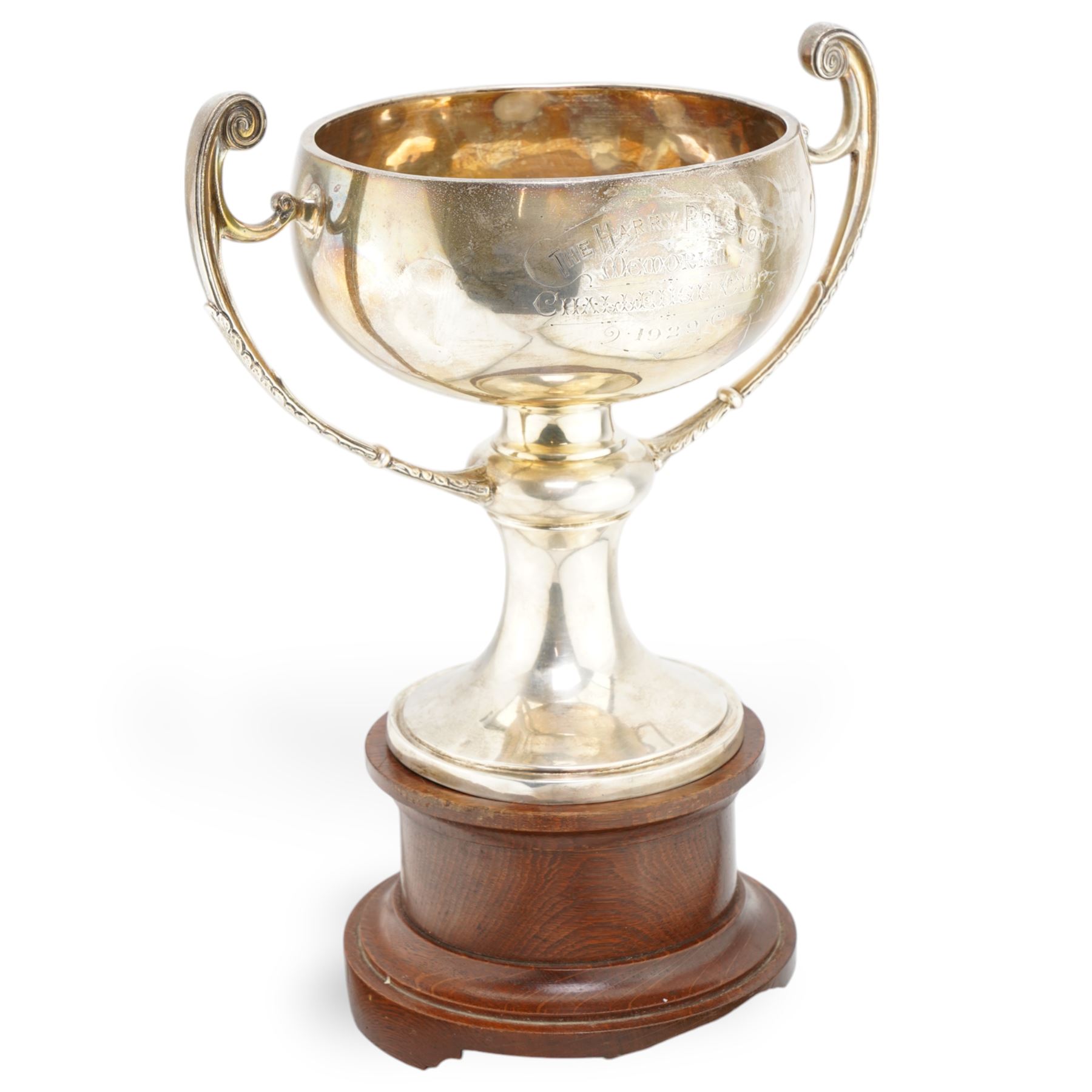 'The Harry Preston Memorial Challenge Cup 1929' - A two handled cup on pedestal base and wooden plinth marked Elkington & Co. H37cm overall Chester 1929 Maker Fattorini & Son