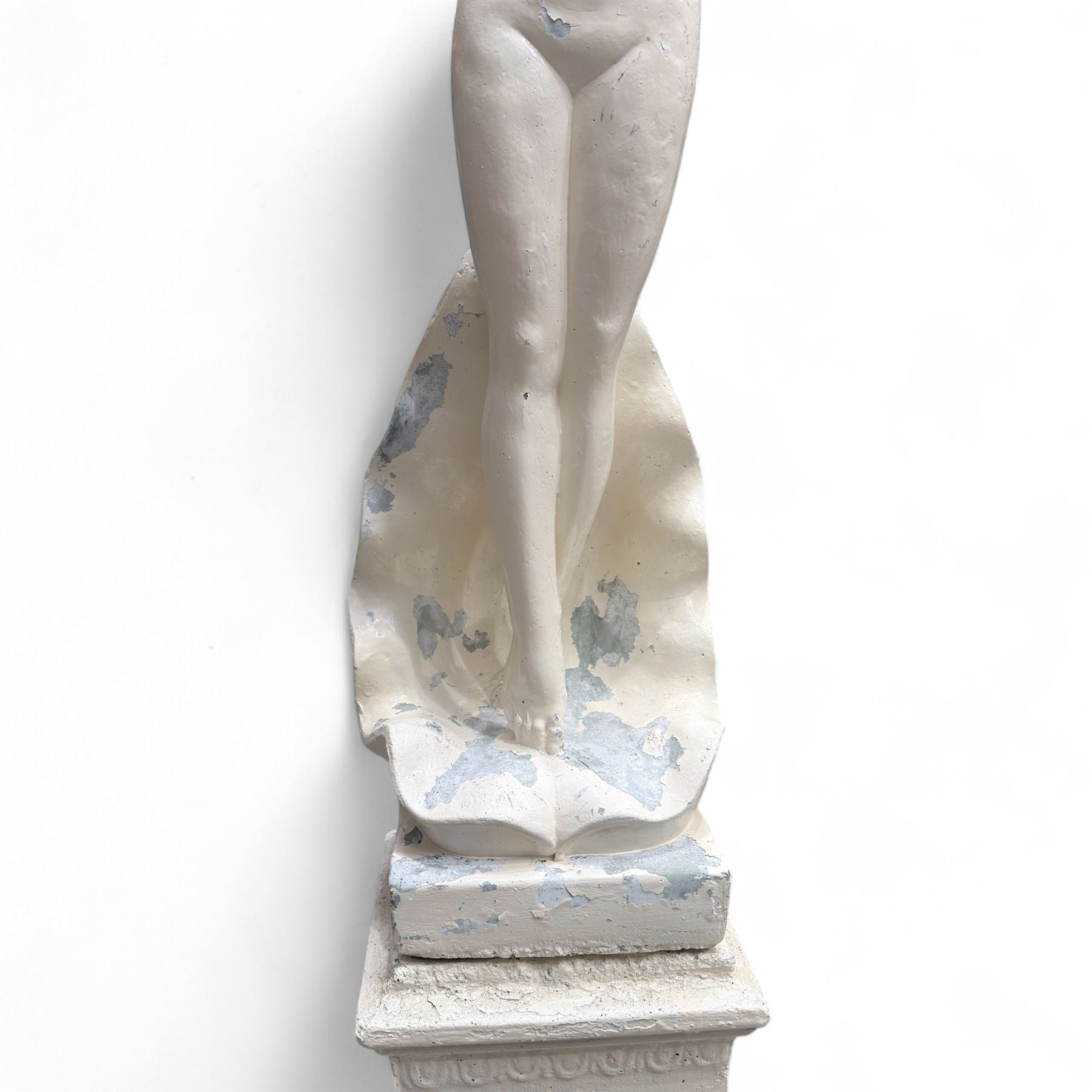 Cast stone garden statue, painted in a white finish on plinth