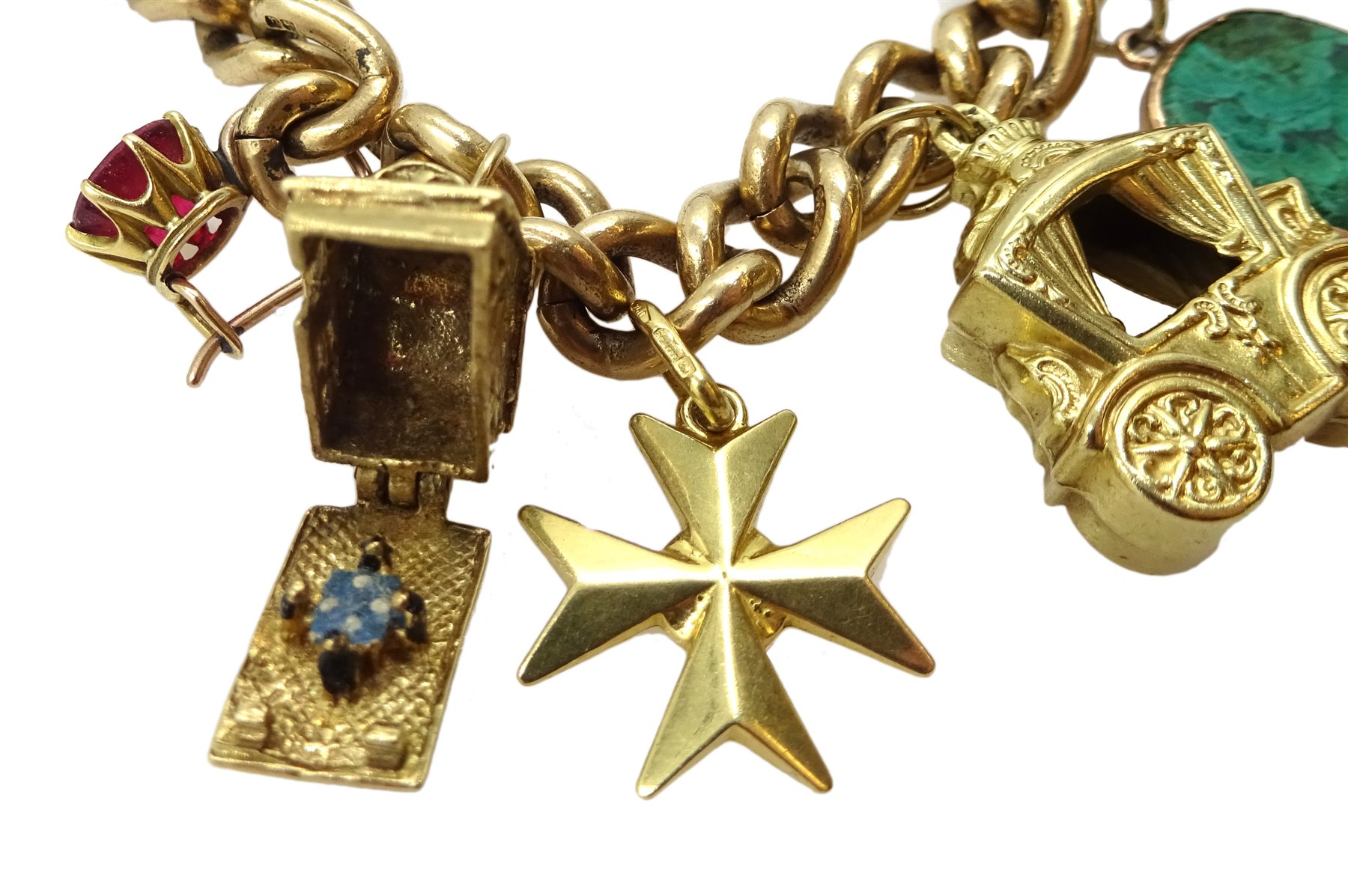 9ct gold curb bracelet with heart locket hallmarked,  with ten 9ct gold charms including stork carrying a baby, house, first aid box and an 18ct gold cross charm, all tested, hallmarked or stamped