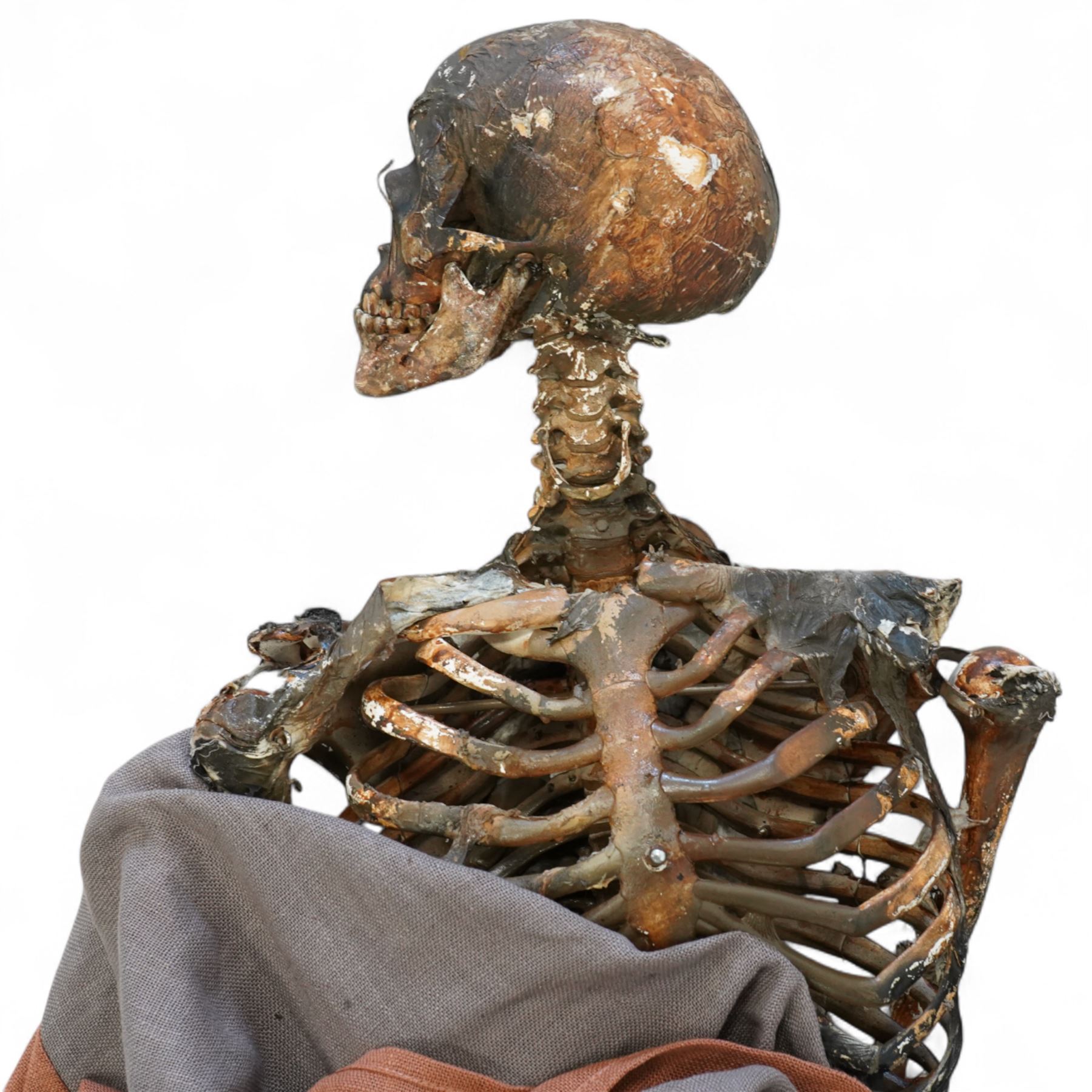 FILM PROPS; Three decomposing prop cadavers, collection of three life-size decomposing cadaver or dead body props, featuring skeletal elements, exposed flesh, and period clothing, each with articulated joints and limbs, likely from a TV or film production, each prop displays intricate detailing with realistic aging and weathering, together with post mortem cards detailing circumstances of death and identity, with two associated body bags max 160cm (3) 
Notes: the post-mortem cards correlate to a plane crash in 1972 - the Uruguay Air Force Flight 571 in the Andes Mountains; two movies were made about this event. Allegedly, the survivors resorted to cannibalism. 