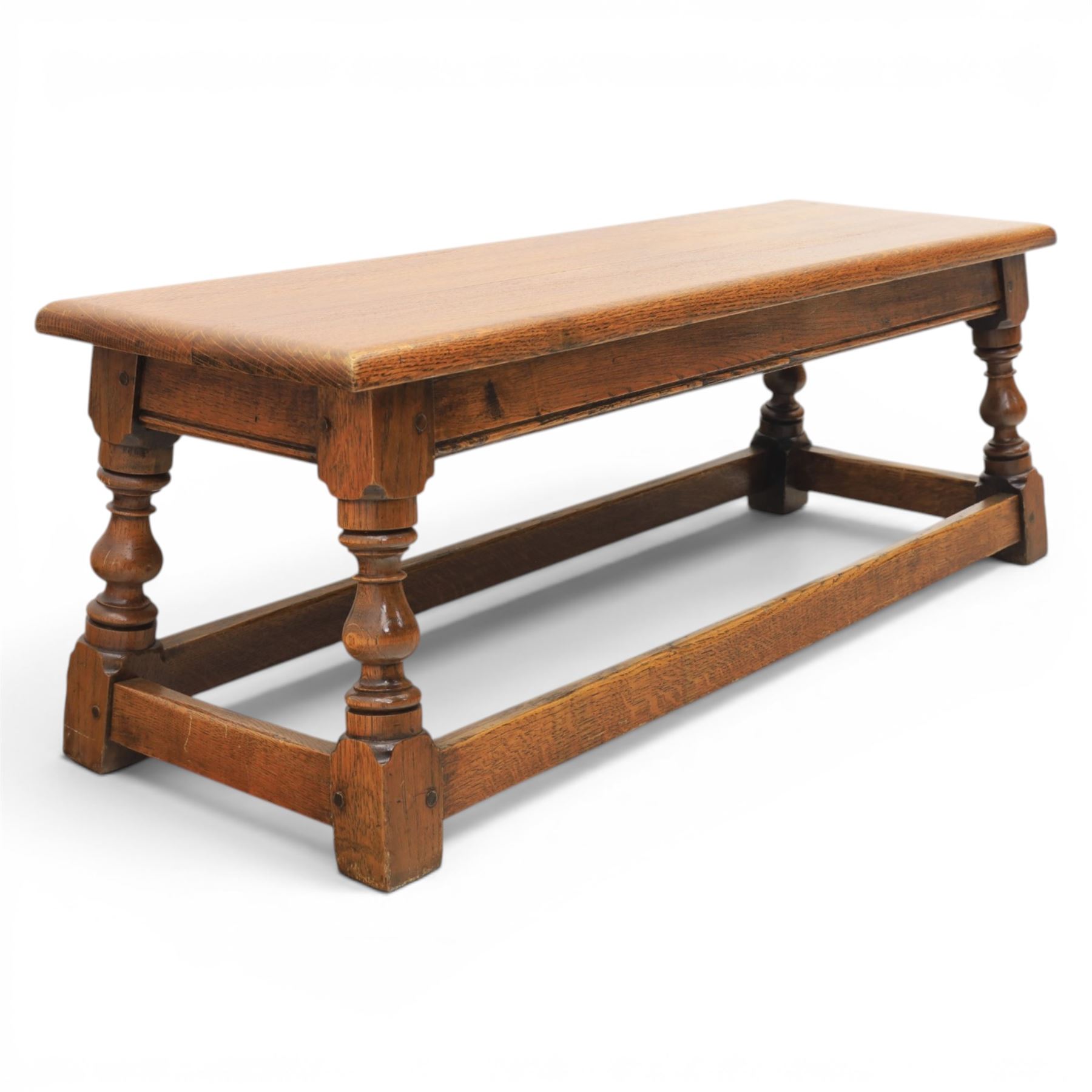 17th century style oak long joint stool, rectangular top with moulded edges, raised on turned supports united by stretchers