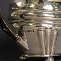 Edwardian silver teapot, of part fluted oval form upon four bun feet, with ebonised handle and finial and presentation engraving to body, hallmarked Thomas Bradbury & Sons, London 1904, H17cm