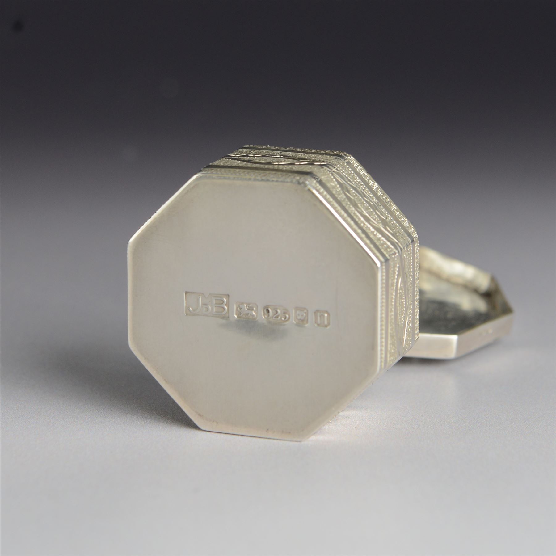 Silver trinket box, of hexagonal form, engraved with entwined snakes to body and decorated to the removable cover with a snake with sapphire set eyes, hallmarked Jonathan Braganza, London 2012, H3cm, W4cm