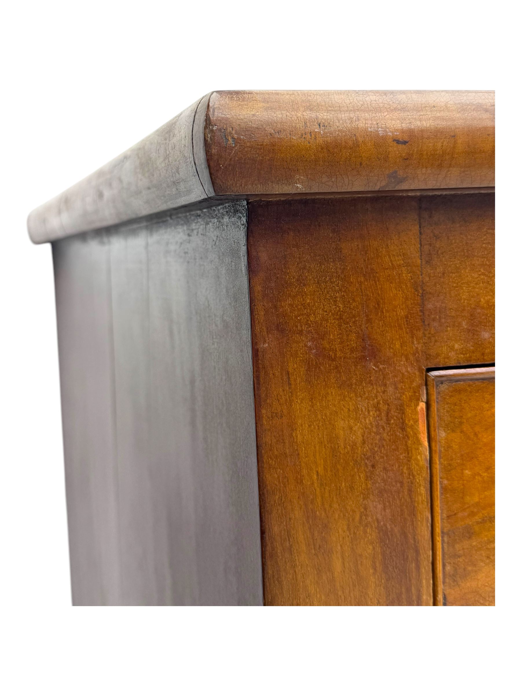 Victorian mahogany bow-fronted chest, fitted with two short over three long graduated cockbeaded drawers, on turned bun supports
