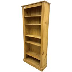 Contemporary pine open bookcase, fitted with five adjustable shelves, skirted base