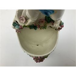 Victorian wall pocket by Moore Brothers retailed by T.Goode modelled as a semi nude white glaze cherub with turquoise ribbon, with encrusted floral decoration, the reverse stamped ‘T.Goode & Co.’, H32cm