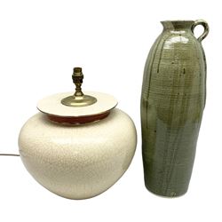 Large cream crackle glaze table lamp, together with a tall studio pottery vase in green with single loop handle, with impressed makers mark, H49cm