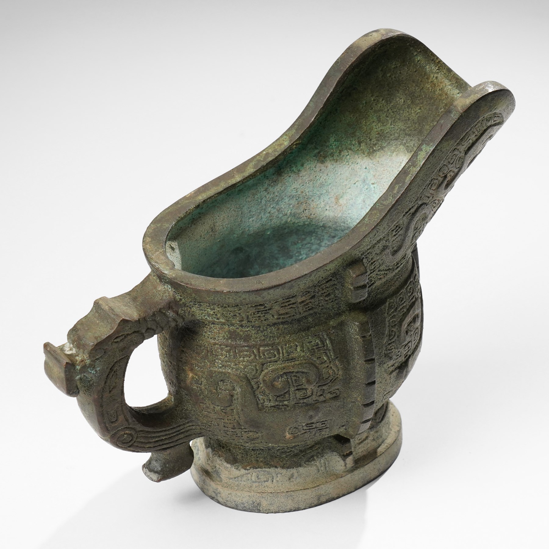 Chinese archaistic bronze wine vessel, Shang dynasty style but 20th century, W25cm; together with a Tang dynasty style model of a rearing horse, H17.5cm (2)