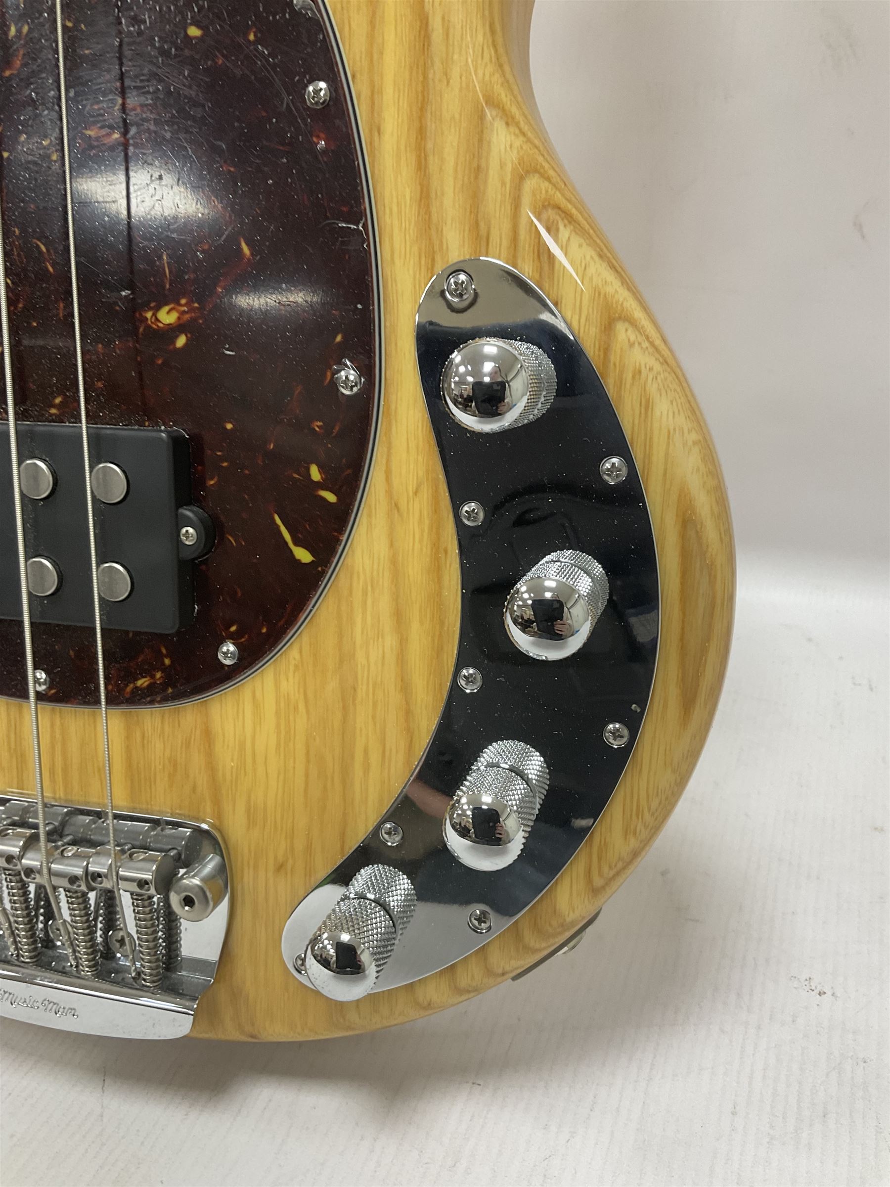Ernie Ball Music Man Sting Ray 4 string bass guitar, in natural finish with roasted maple neck and tortoiseshell effect scratch guard, serial no 87485, in black Music Man hard case, guitar L114cm