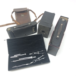  No. 2C Folding Autographic Brownie with original box, No. 2A Folding Autographic Brownie with leather case, box camera and cased set of Jakar drawing instruments   