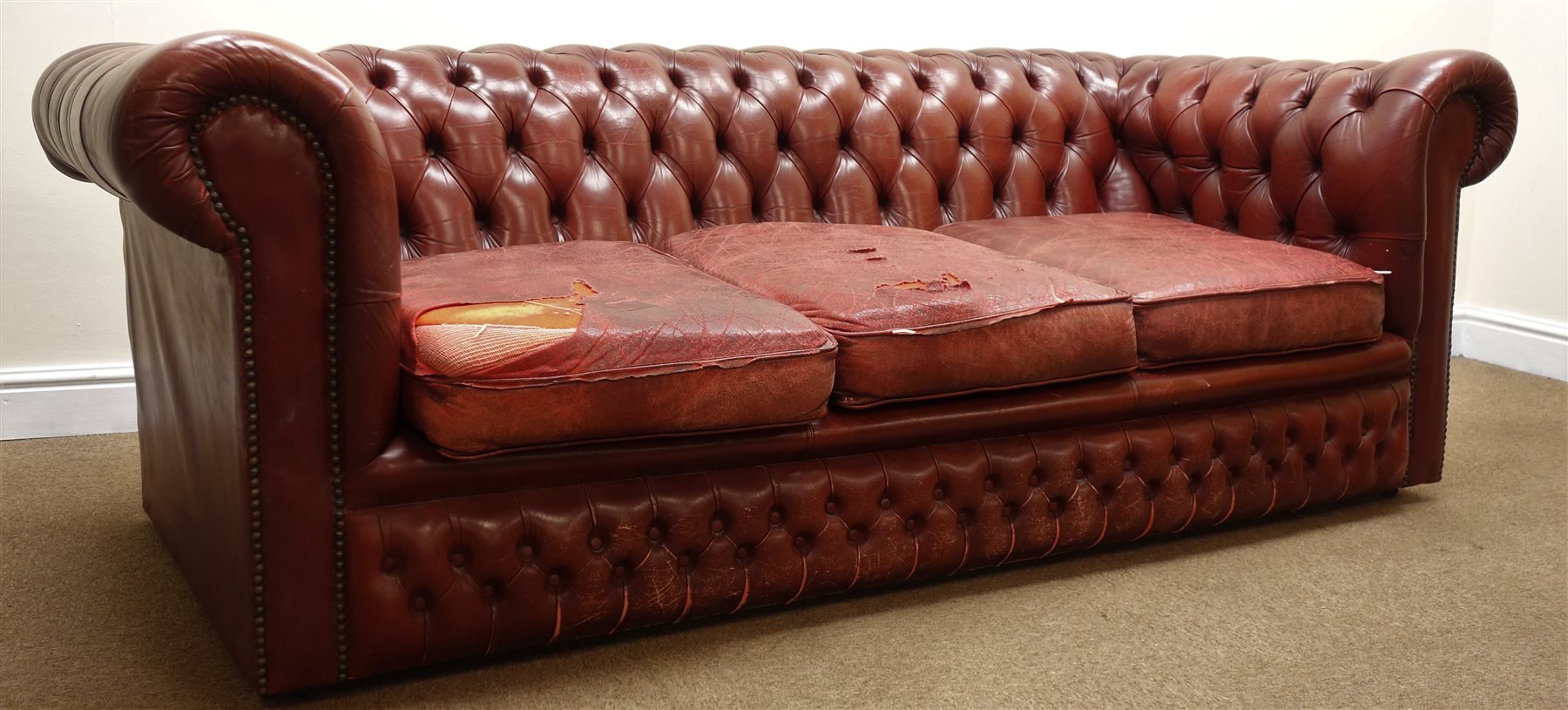 Three seat Chesterfield sofa upholstered in deep buttoned ox blood leather, W200cm The