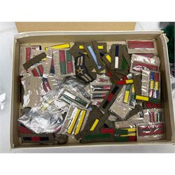 Quantity of military horse hair plumes and feather hackles, cloth stripes and regimental titles etc