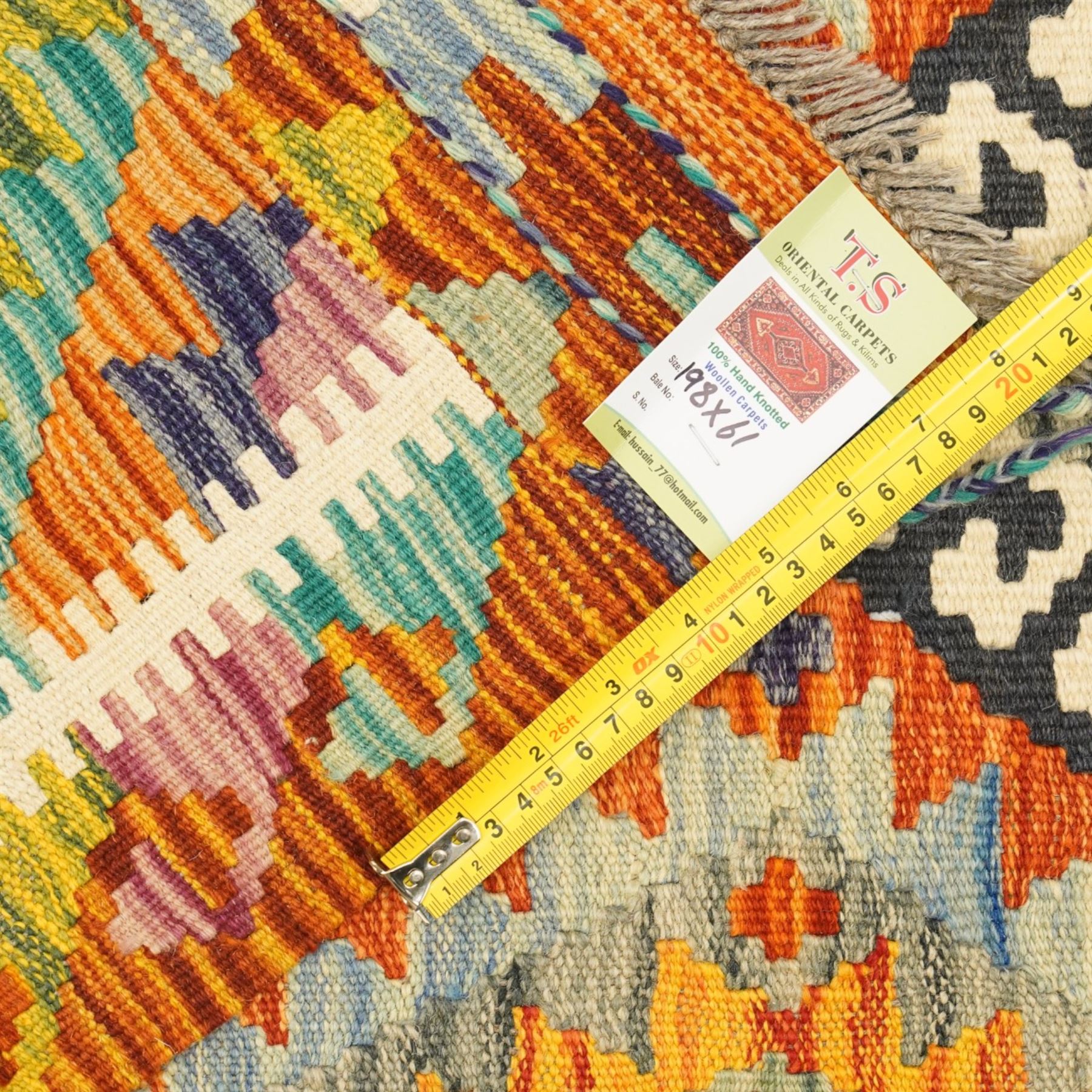 Afghan Chobi flatweave kilim runner, with a repeating stepped diamond medallion design in ivory, green, rust, teal, purple, indigo, and framed by chevron and geometric borders