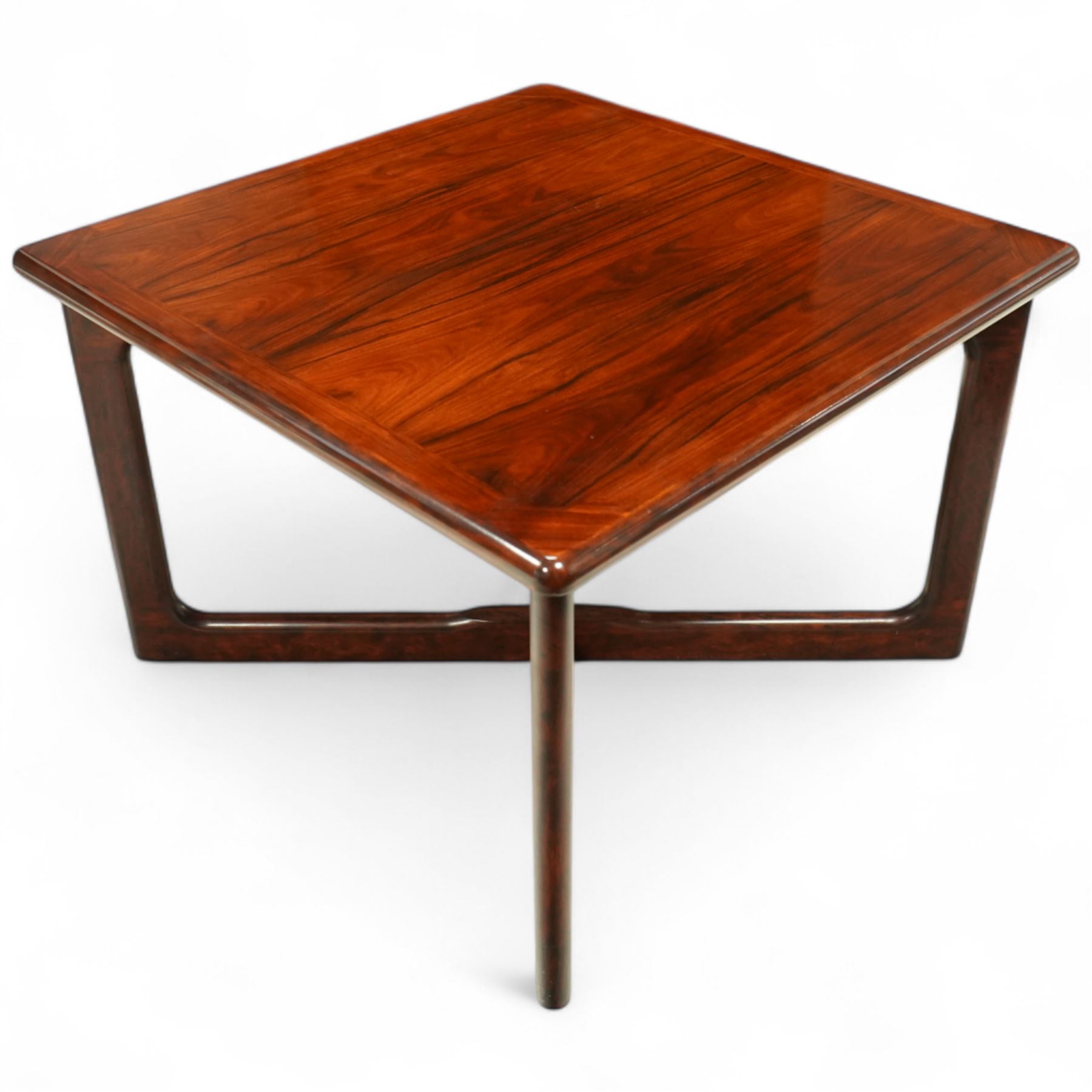 Dyrlund - contemporary Santos rosewood coffee table, floating design, square top of elegant design with clean lines and chamfered square legs 

Note: Dyrlund is a Danish furniture manufacturer known for its high-quality, handcrafted pieces, particularly in the mid-century modern style. Founded in 1960 by Frits Hjerte Dyrlund in Rude, Denmark, the company has remained a family business, now run by the second and third generations. Dyrlund specializes in both home and executive office furniture, focusing on practicality, solid construction, and classic design