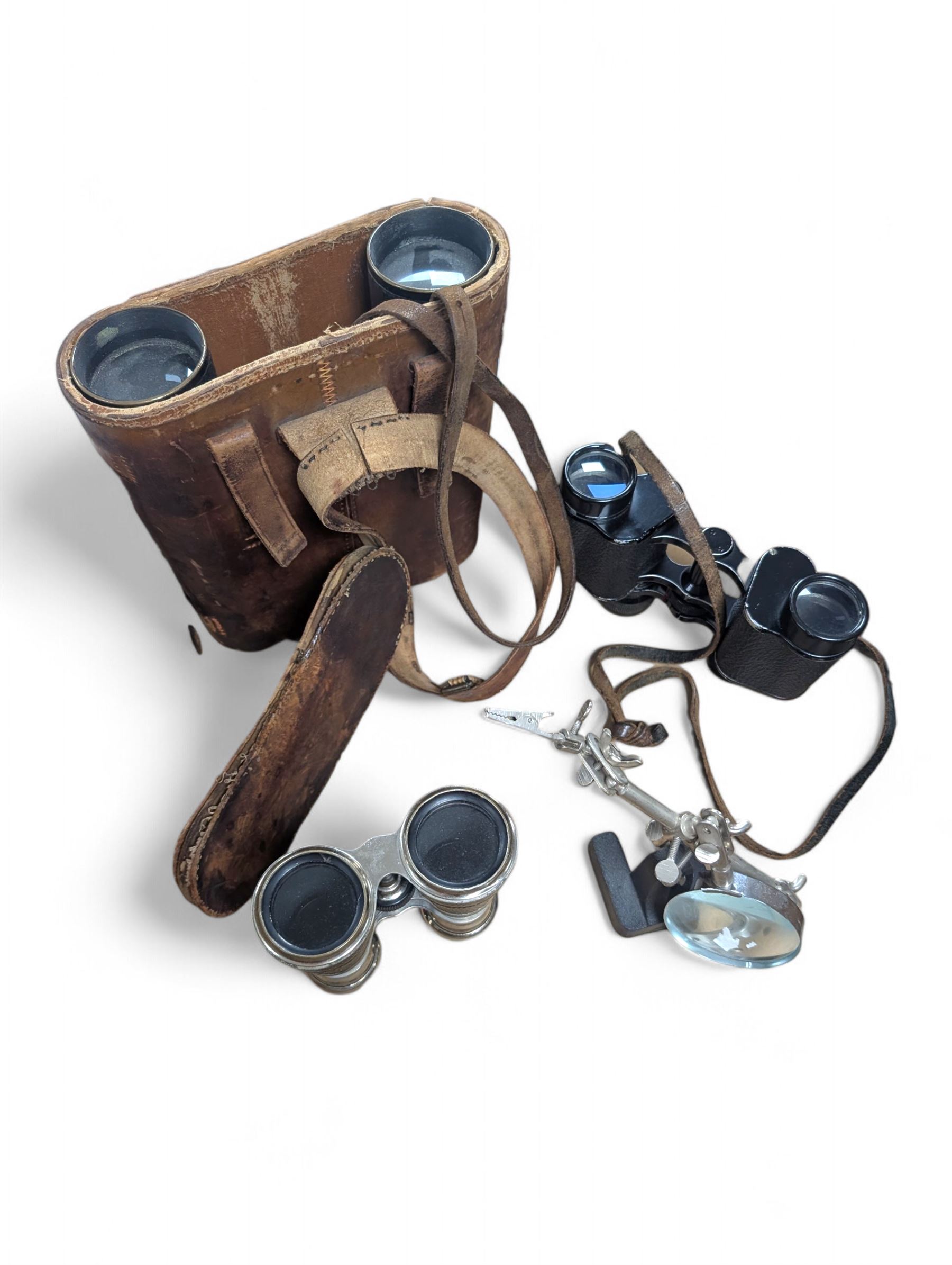 Three pairs of binoculars including Wrayvu 8x30 and Busch Hellux, together with a tabletop magnifying glass