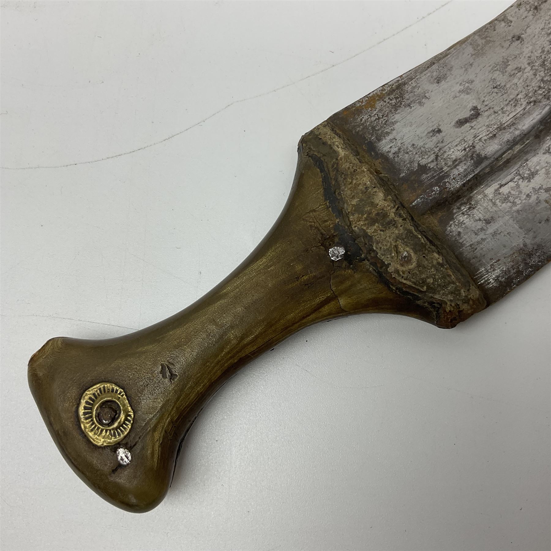 Late 19th century Yemeni Tuza jambiya as worn by religious elite, the 20.5cm curving blade with raised medial ridge, the horn hilt with pique style studwork, in a leather wrapped wooden scabbard with pierced metal mount and leather belt applied with embroidered 'gold' and 'silver' thread work panel; dagger L36cm overall, belt L84cm