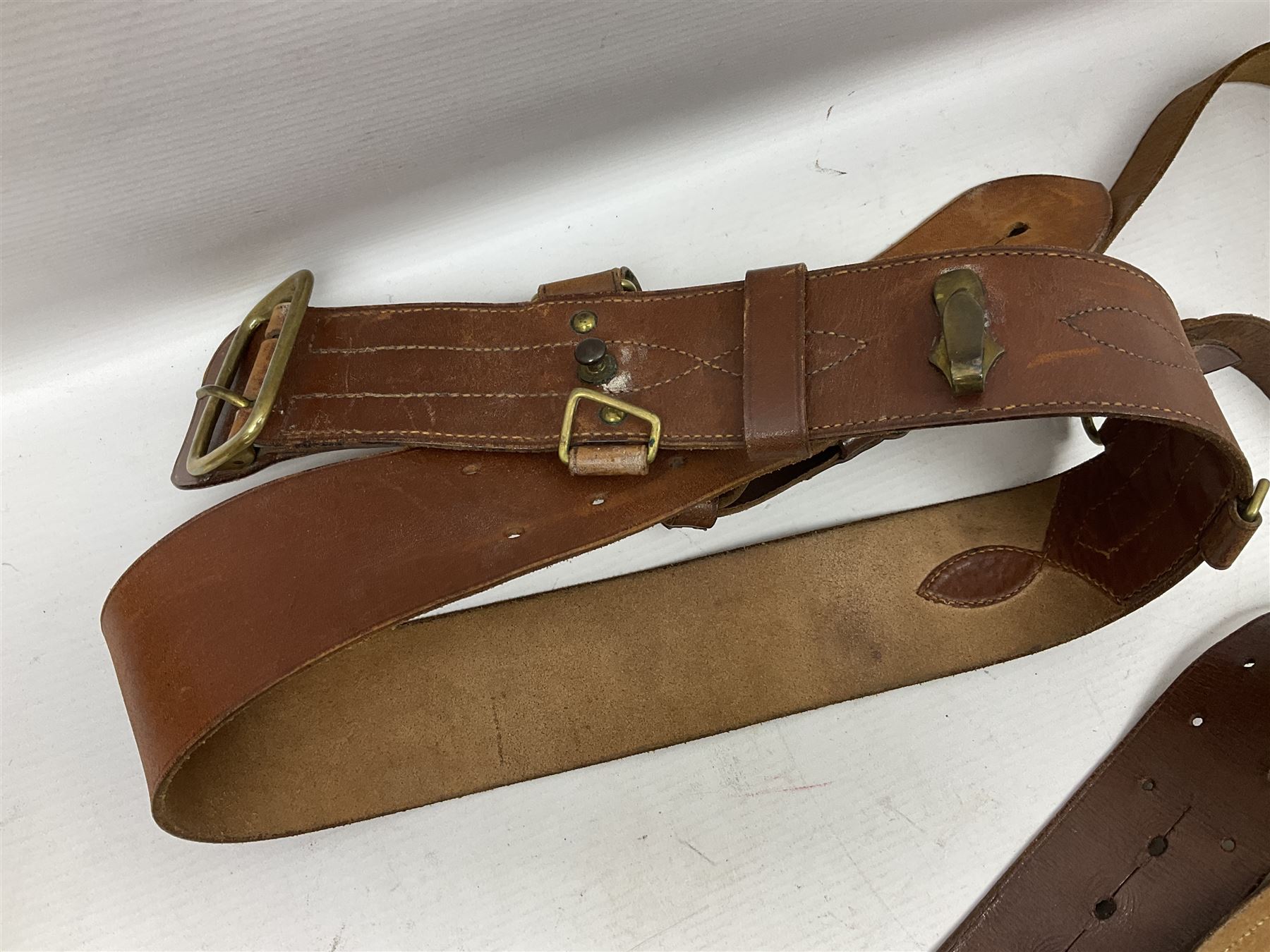 British Army General Staff officer's peaked cap by Herbert Johnson London in Moss Bros. delivery box; two officer's Sam Browne leather belts; leather pistol holster and sword hanger; pair of leather gloves and pair of spurs