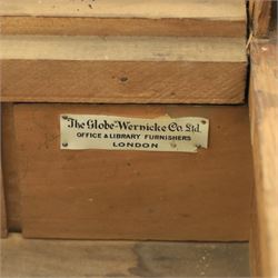 Globe Wernicke - Oak roll top desk, fitted with nine drawers, oak tambour roll top revealing a fitted interior, with single frieze drawer, flanked by four drawers to each pedestal, on a plinth base