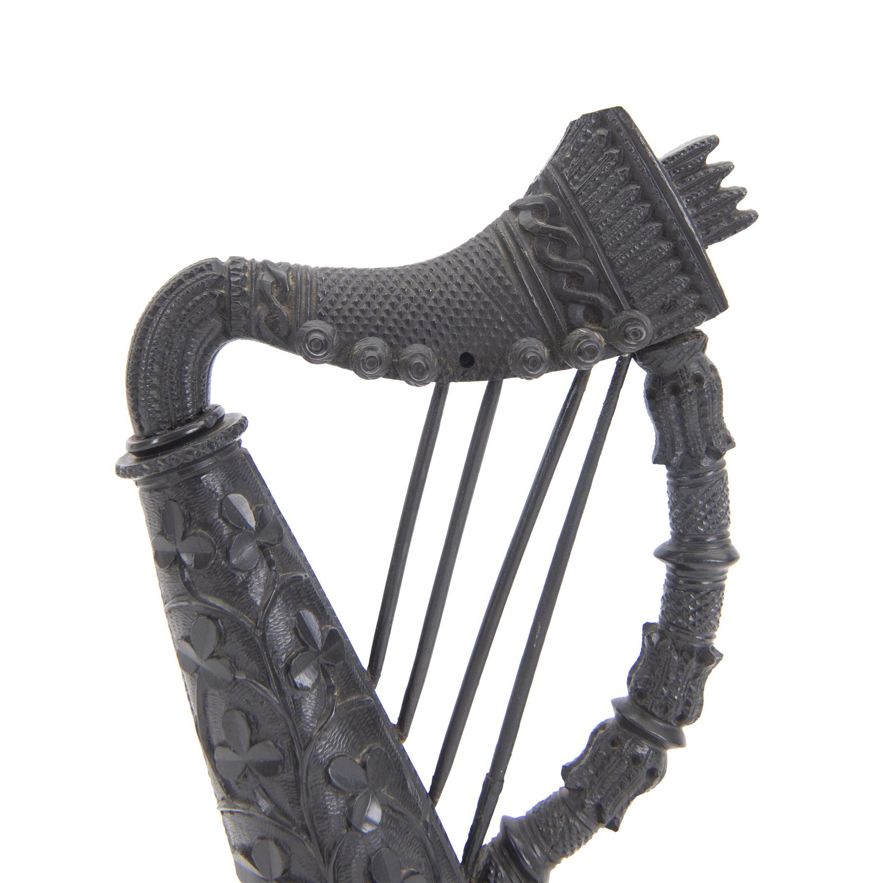 19th century Irish carved bog oak model of a harp, detailed with fluting, diamond cuts and shamrocks, upon a turned circular base, H29cm
