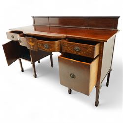 Edwardian Sheraton Revival inlaid plum pudding mahogany serpentine sideboard, rectangular top with raised gallery above bowed frieze drawer finely inlaid with central neoclassical urn motif, flanked by two drawers with swags and ribbon bows, above a cellarette drawer and cupboard, on square tapered supports with spade feet 
