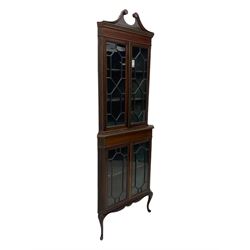 Edwardian mahogany corner display cabinet, scrolled swan neck pediment over astragal glazed doors, fabric lined interior, on cabriole feet 
