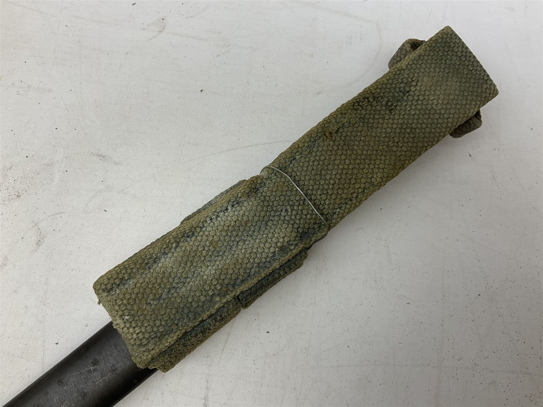 Italian Model 1891 Carcano knife bayonet with 30cm fullered steel blade, the cross-piece stamped VL1110; in steel scabbard with webbing frog L43cm overall; and another Italian fighting knife/bayonet in brass bound leather scabbard (2)