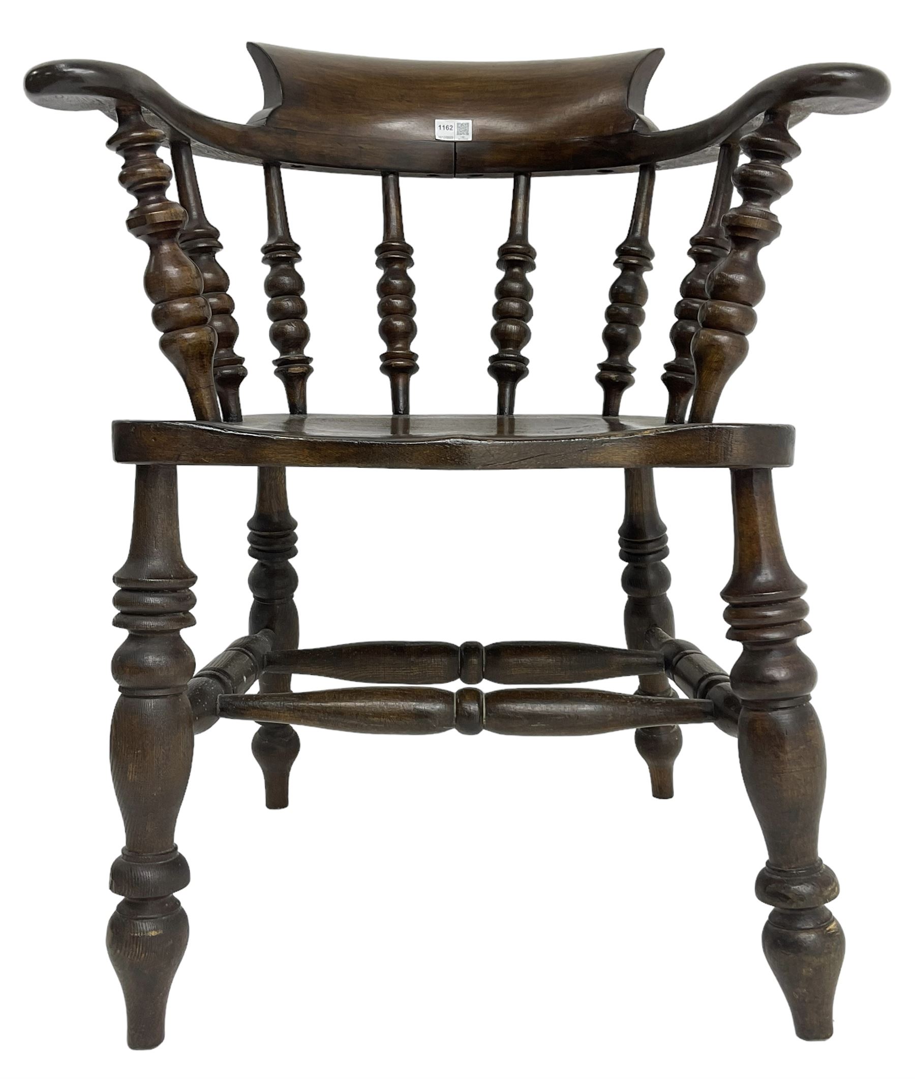 Early 20th century stained beech captains smokers bow chair, spindle tub shaped back over saddle seat, raised on turned supports united by double H-stretcher