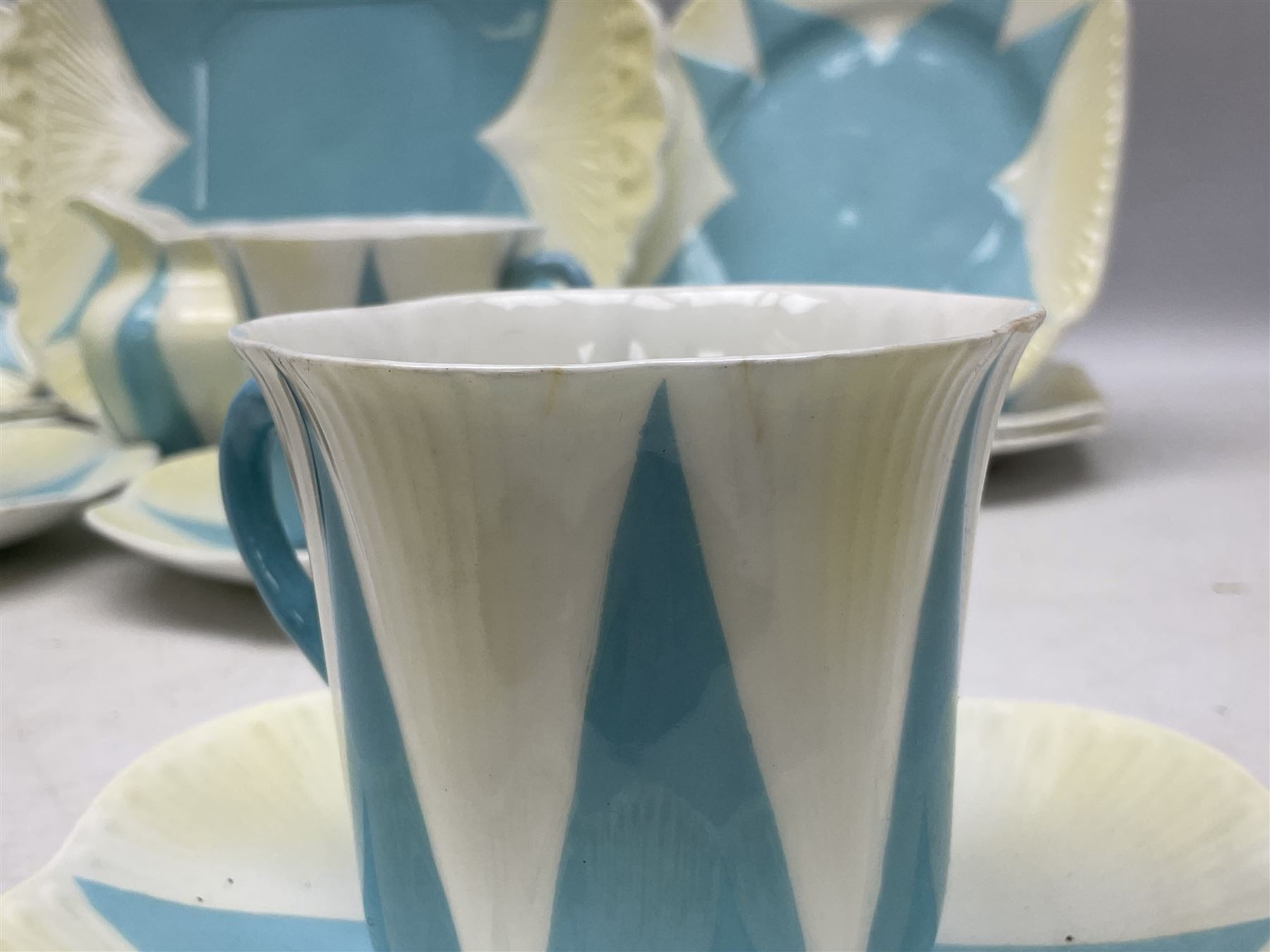 Shelley Dainty pattern tea wares, of lobed form with blue star decoration on merging white and yellow ground, comprising five teacups, five saucers, six tea plates, milk jug and cake plate, all with printed green mark beneath, some with painted pattern no 11770