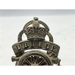 Trench Art - three WW2 brass shell case ashtrays, one mounted with Royal Artillery cap badge and button and one mounted with RA button; together with a pair of place name holders each formed from a Royal Artillery cap badge (5)