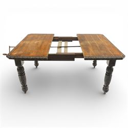19th century heavily carved oak extending dining table, with winding mechanism and a gadrooned edge, over block and turned supports terminating in castors, extends to 147cm