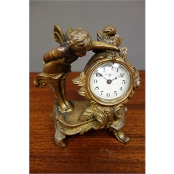  Small gilt metal cartouche mantel clock, with winged putti figure, circular Arabic dial, H15cm  