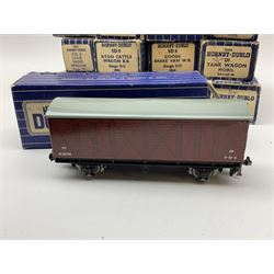 Hornby Dublo - twenty wagons including Cattle Truck; Low-Sided Wagons; Cable Drum Wagon; Tank Wagons for Shell Lubricating Oil, Esso and Mobil; Mineral Wagon; 20-Ton Bulk Grain Wagons; Goods Brake Vans; Coal and Sand Wagons; Refrigerated Van; Double Bolster Wagon with timber load etc; all in blue striped boxes (20)