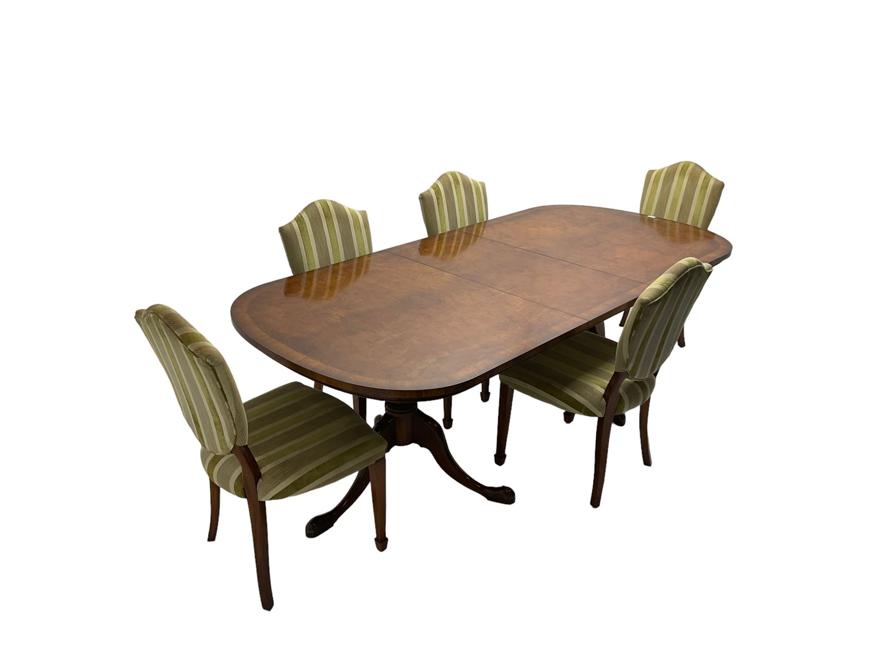 Regency design walnut twin pedestal extending dining table, rectangular burr top with rounded corners and crossbanding, raised on turned vasiform columns with tripod base, with additional leaf (D107cm W184cm/230cm, H76cm); and set eight (6+2) shield back dining chairs, upholstered in striped laurel green fabric, raised on tapering supports with spade feet, retailed by Geoffrey Benson