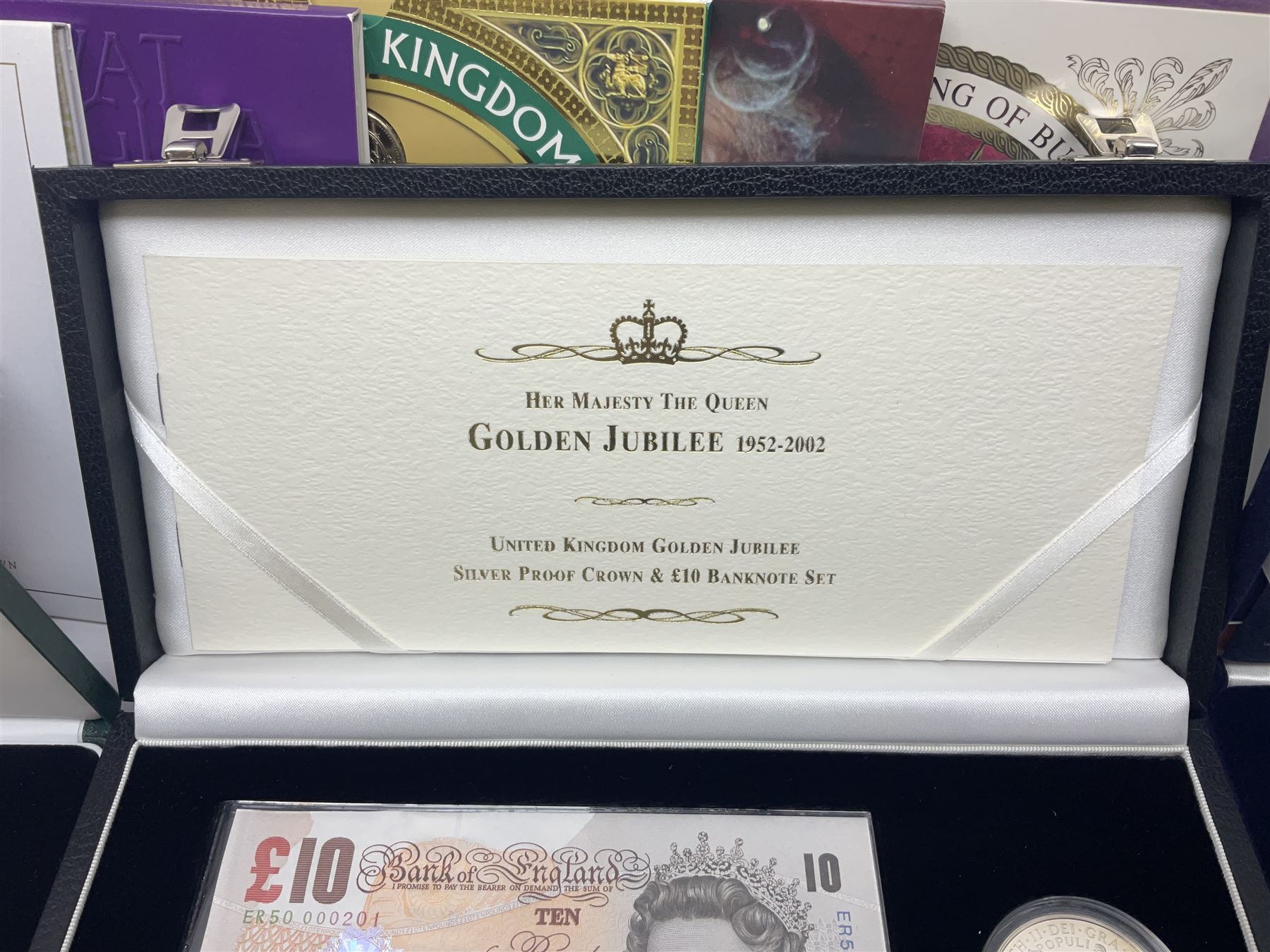 The Royal Mint United Kingdom 'Millennium' silver proof two coin set comprising 1999 and 2000 five pound coins, 2000 'The Queen Mother Centenary Year' silver proof crown, 2001silver proof one pound, 'Her Majesty The Queen Golden Jubilee 1952-2002' silver proof 2002 five pound coin and ten pound banknote set, all being cased with certificates, United Kingdom 1999 brilliant uncirculated coin collection in card folder, other commemorative coinage etc