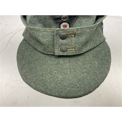 WW2 German Army M43 field cap with triangular cloth eagle and roundel badge and metal edelweiss badge for mountain troops; faintly stamped '5 VMF(?)'