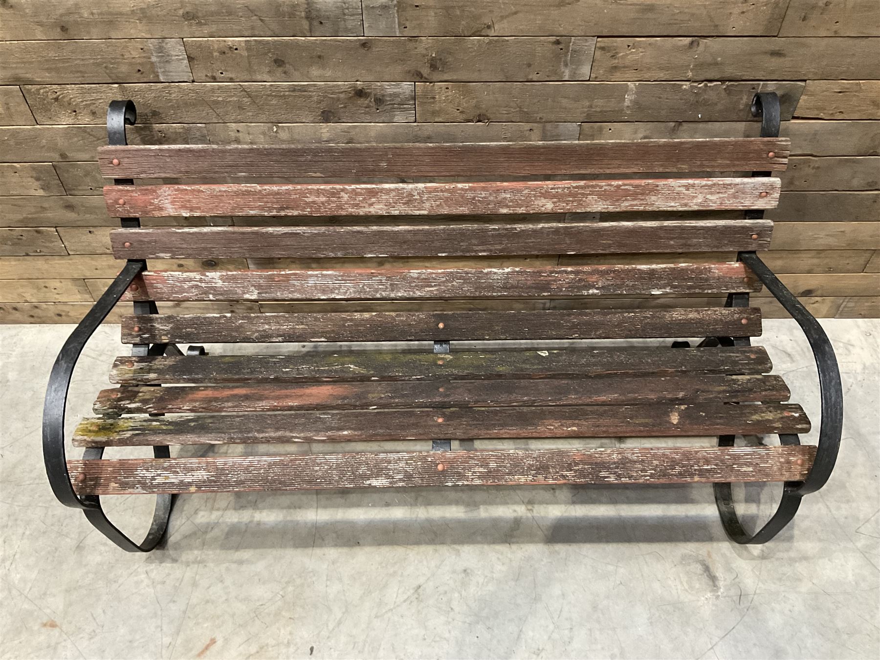 Early 20th century black painted wrought iron and wood slatted garden bench